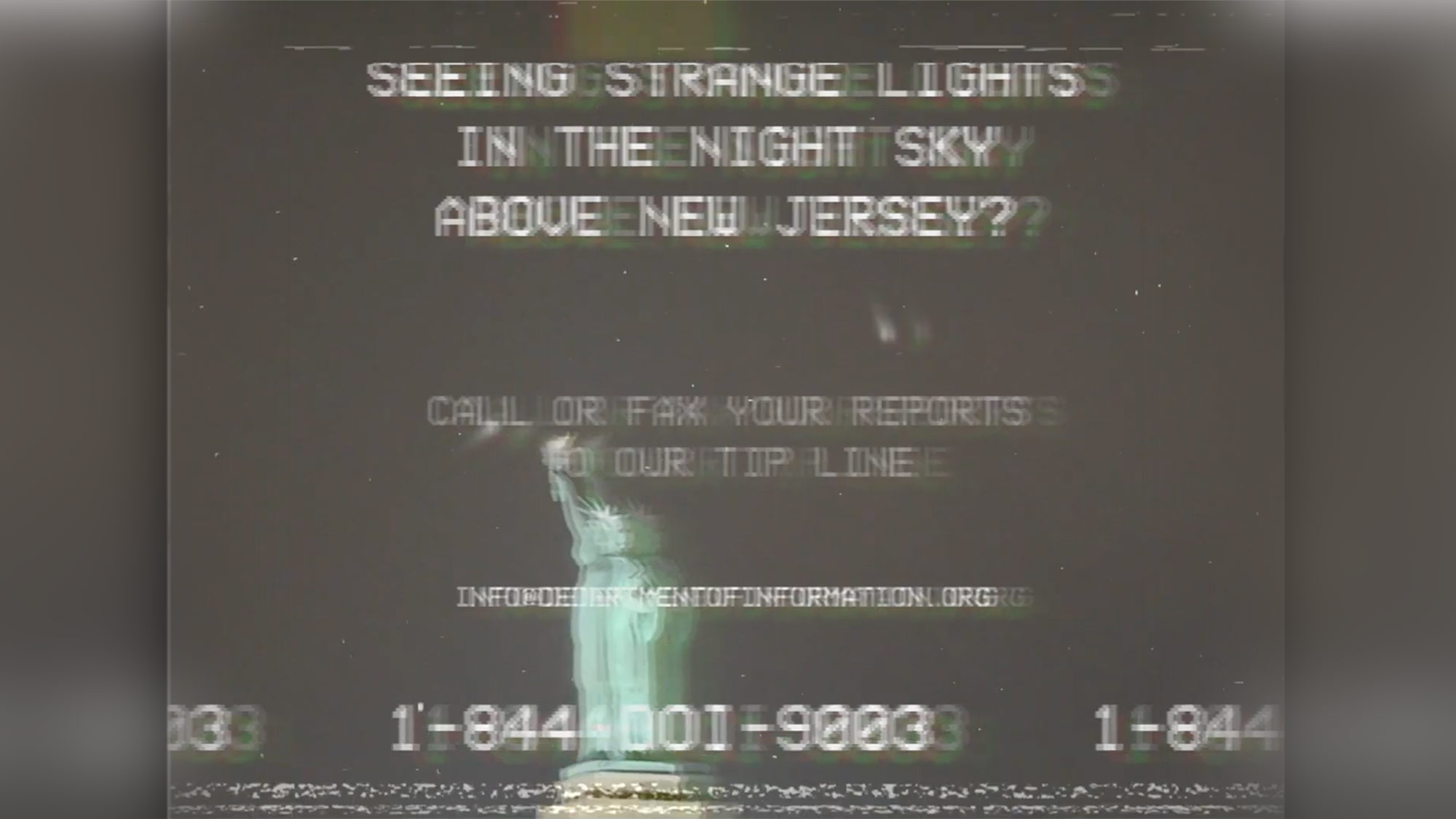 A screengrab from a poorly made vhs tape-looking video of some cool lights floating above the statue of liberty at night