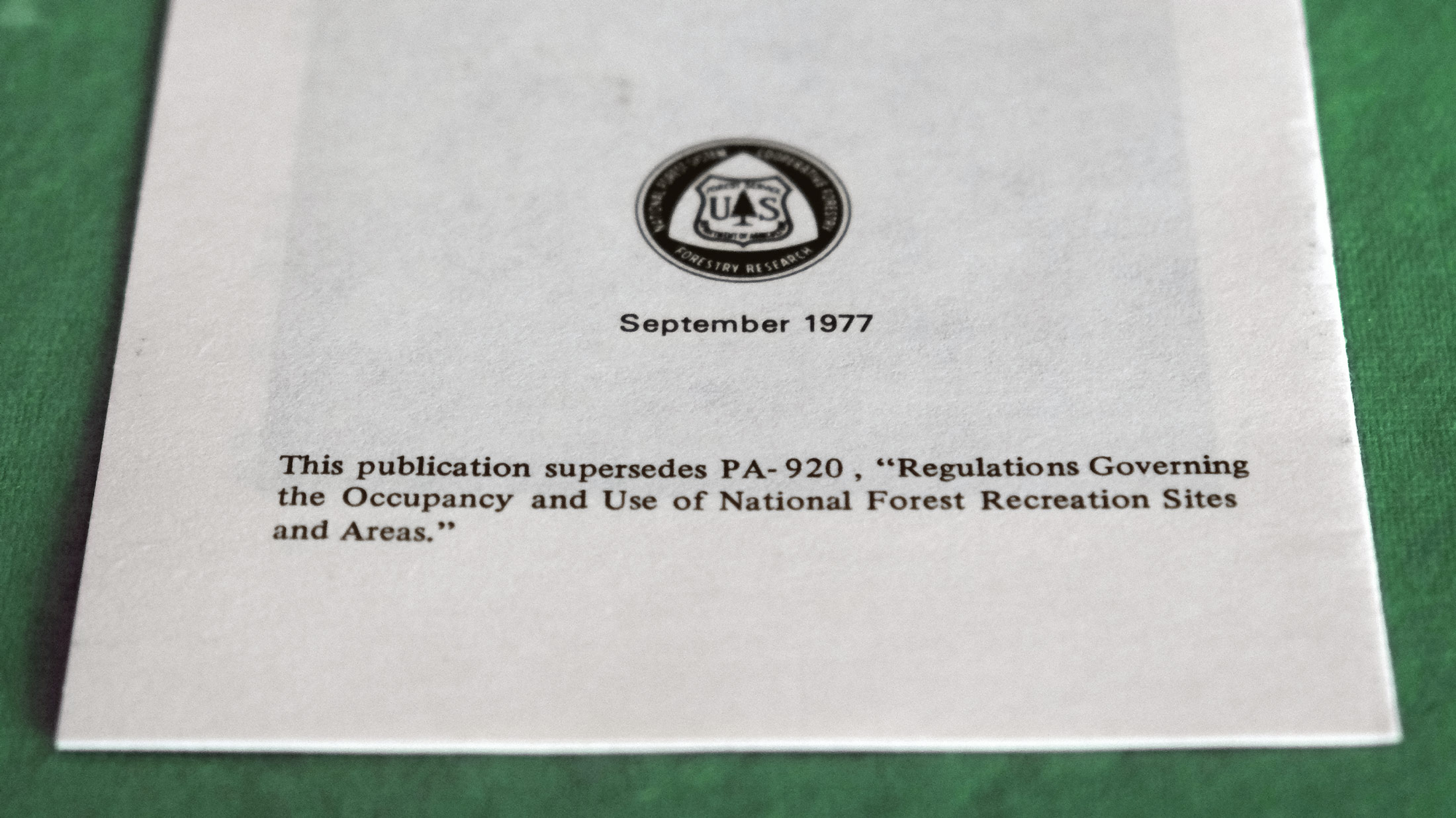 The back of a vintage forest service shows the forest service logo and a short legal notice with the date September 1977