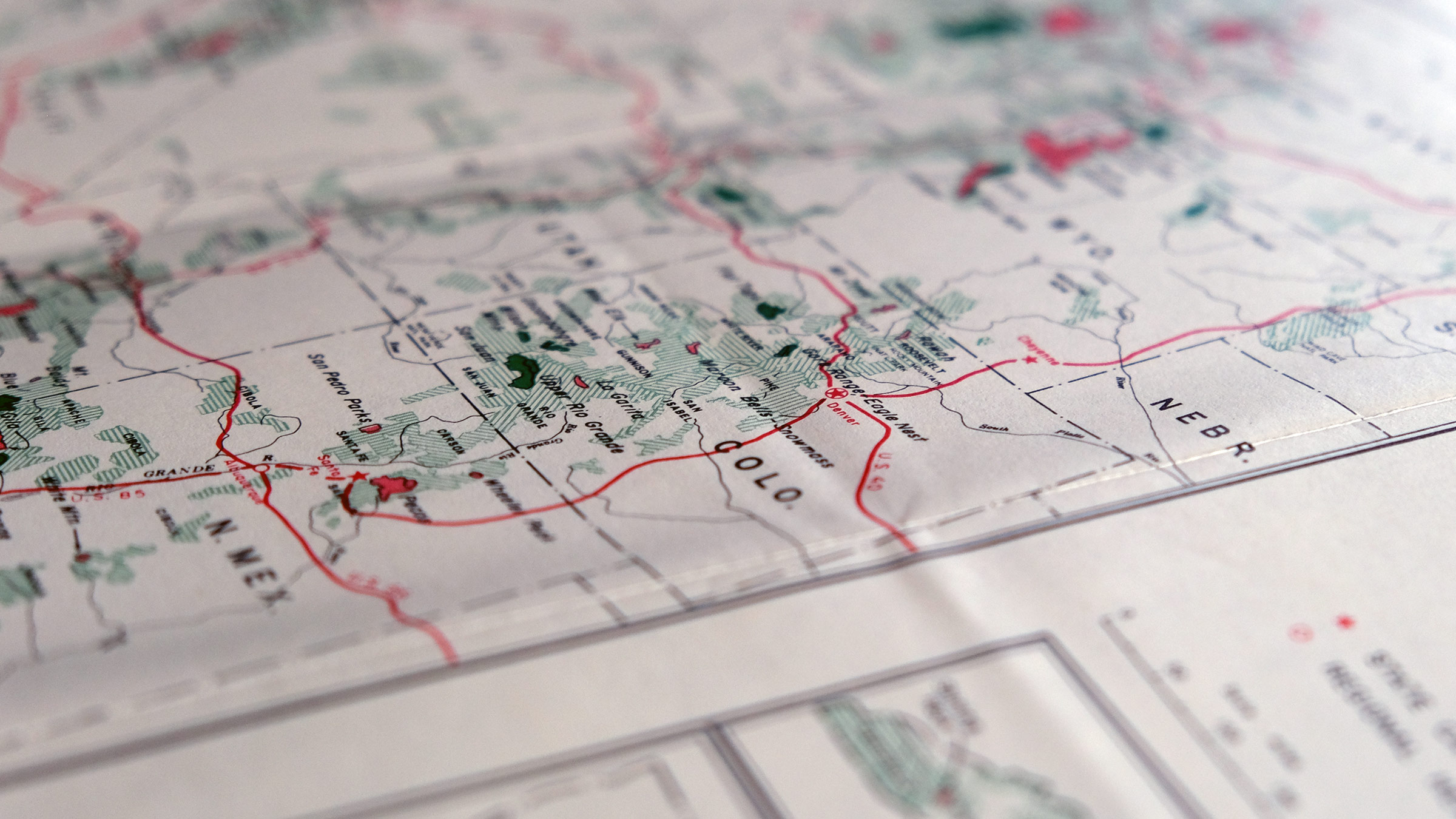 A very close and zoomed focus blurred photograph of a map of western states for hiking, camping, and navigation