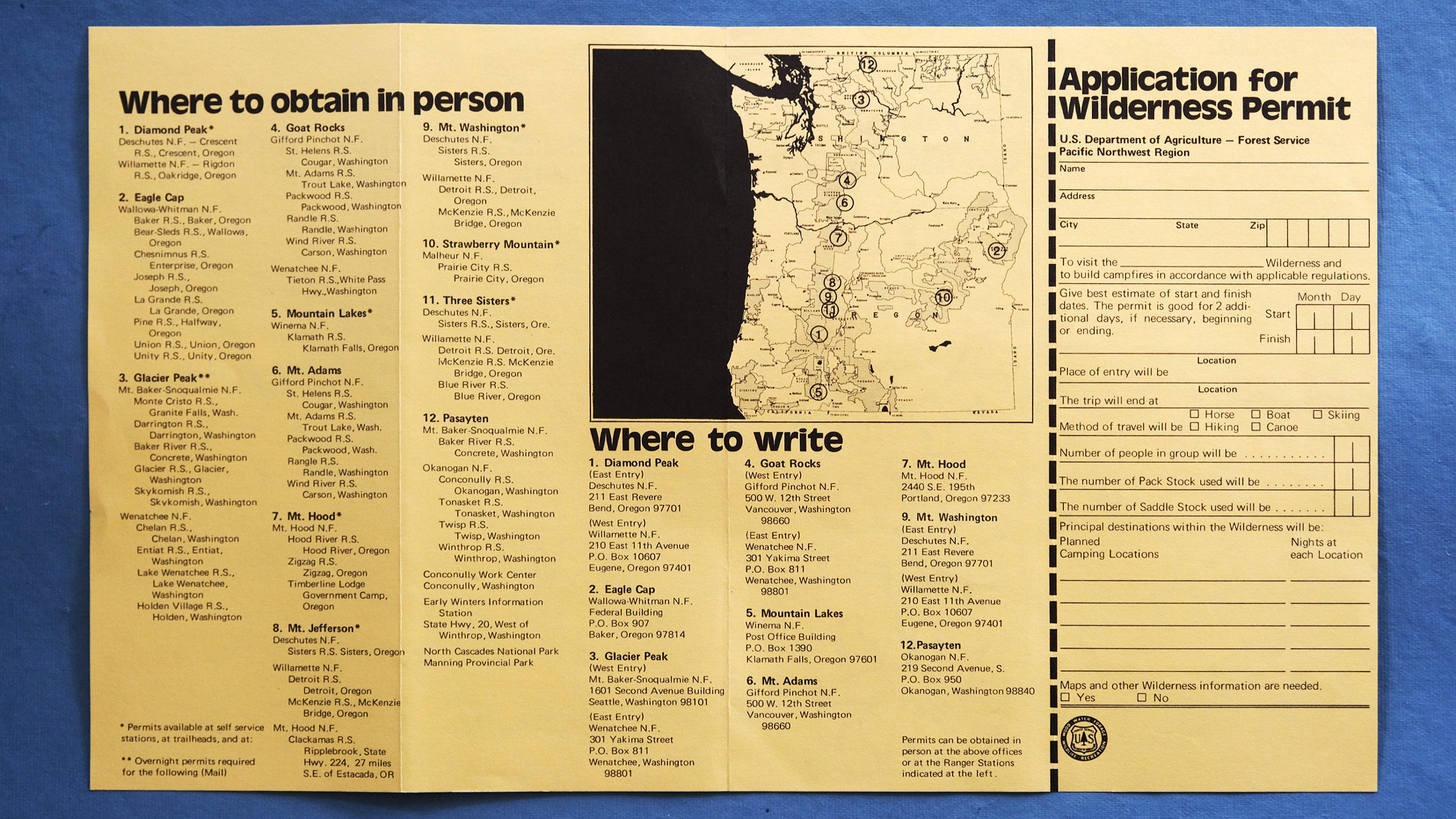 A yellow foldout brochure for Application for wilderness permit shows a bunch of text and a map of Oregon and Washington States