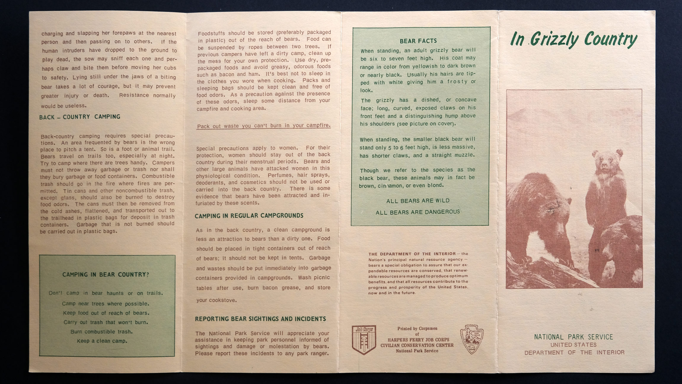 A quad fold vintage Park Service pamphlet called In Grizzly Country shows a family of grizzly bears on the cover below the title, in the other columns is a lot of text about bear safety and bear facts